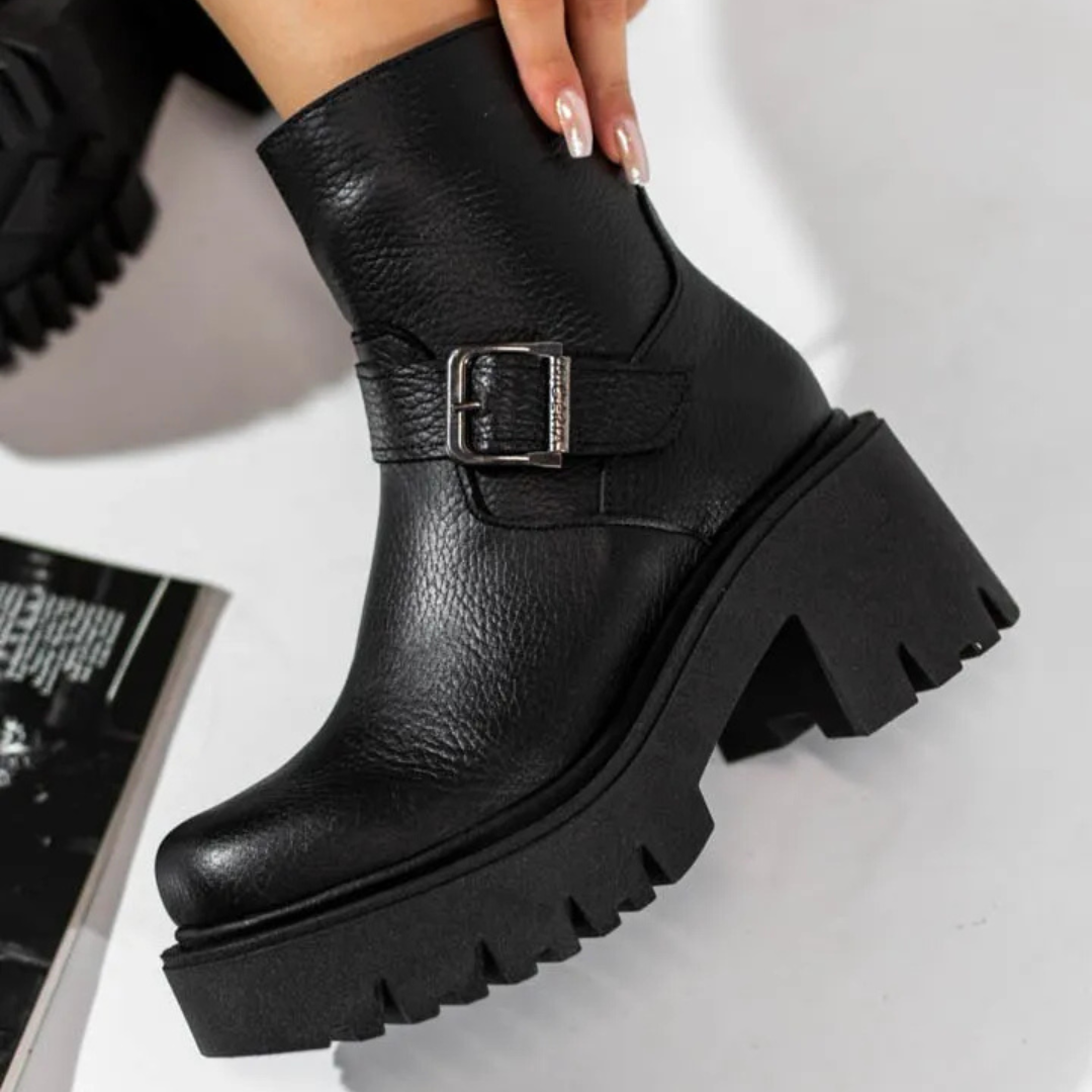 Women's leather boots with low heels and decorative buckles