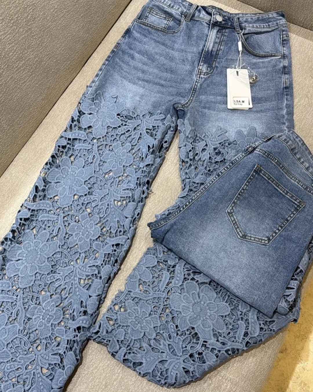Women's jeans with floral lace on the legs