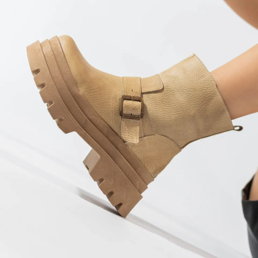 Women's leather boots with low heels and decorative buckles